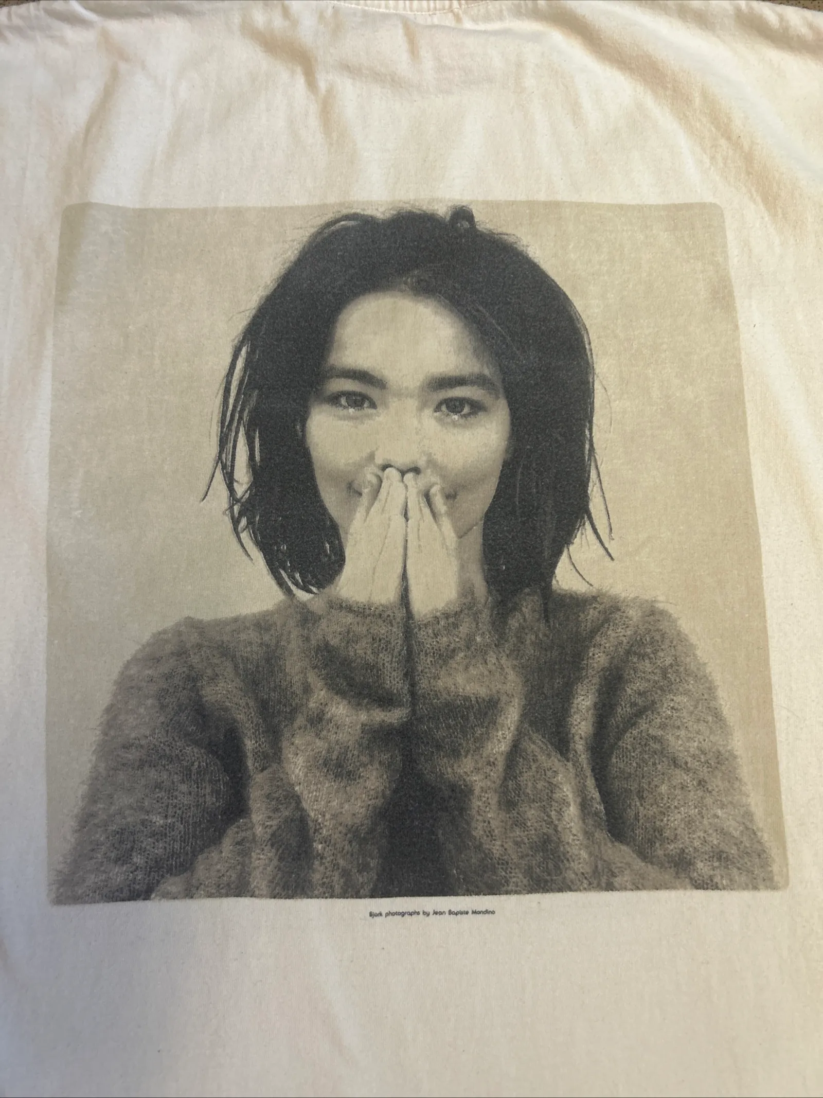Close-up of a different Björk Debut shirt showing a small printed credit line beneath the photograph.