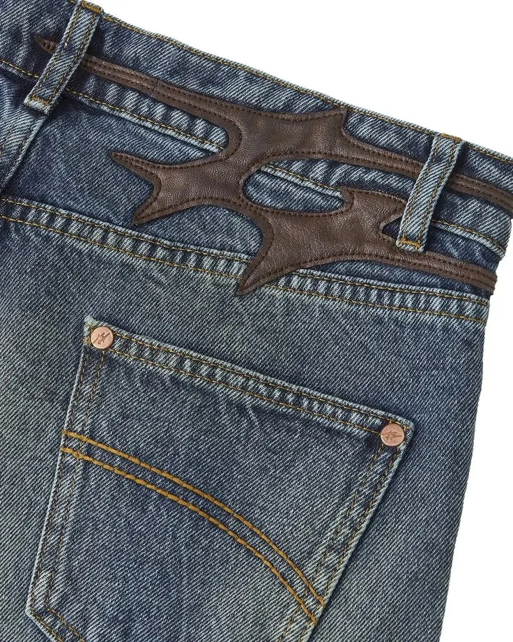Jeans with a decorative dark brown leather yoke shaped like a flame across the back.