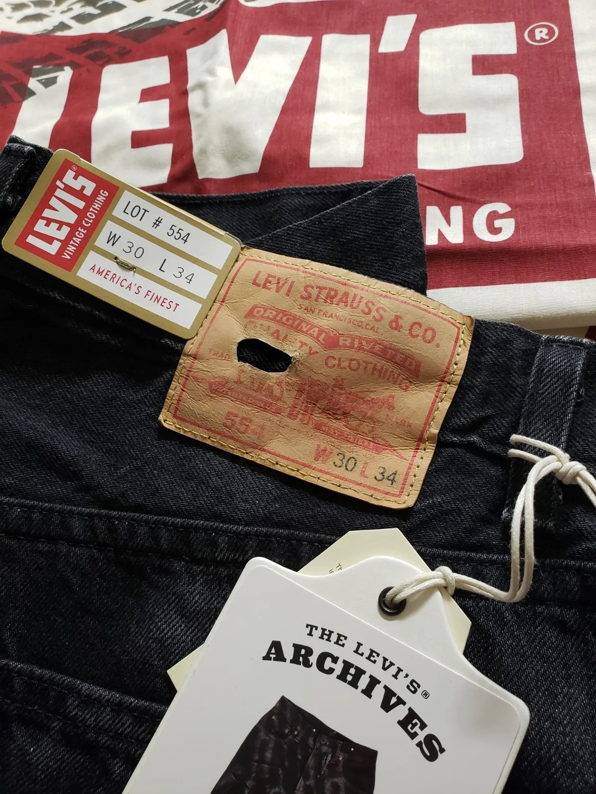 Levi's Vintage Clothing jeans at the waistband, showing a Two Horse leather patch and a gold LVC flasher.