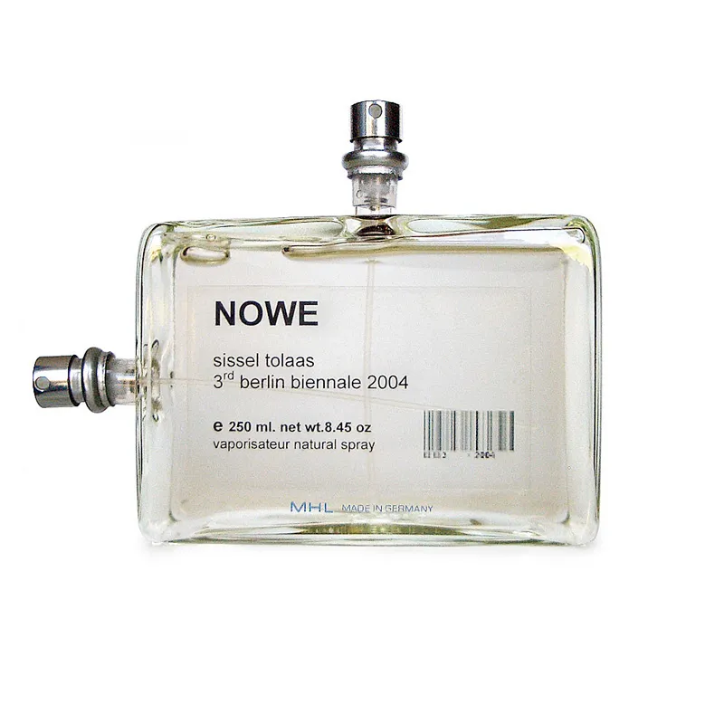 A perfume bottle labeled NOWE, sissel tolaas, 3rd berlin biennale 2004, with two metal spray nozzles at its top and left edges.
