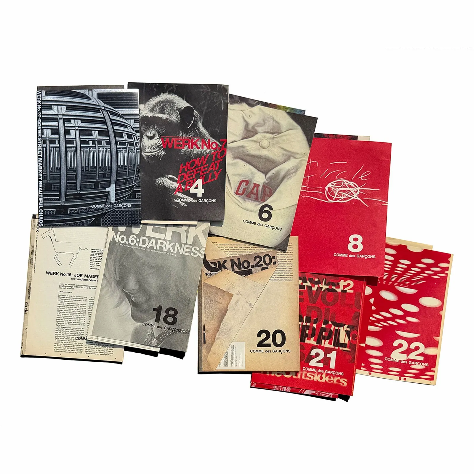 Flatlay of nine Comme des Garcons WERK direct mail issues from 2016, including covers reading Beautiful Chaos, 3 Cap, and Dover Street Market.