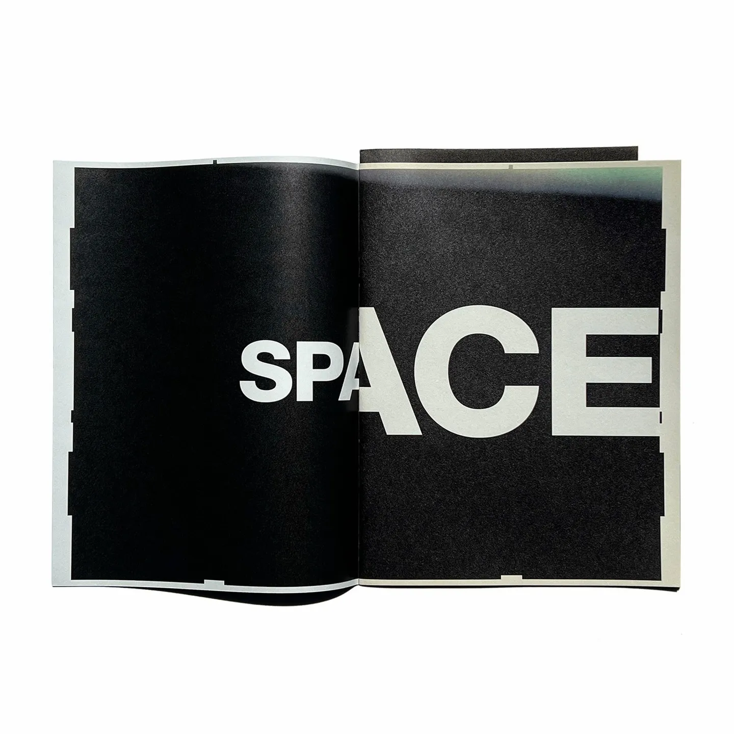 Interior spread from a 2016 Comme des Garcons WERK zine, black pages with the word SPACE set in large white type across the gutter.