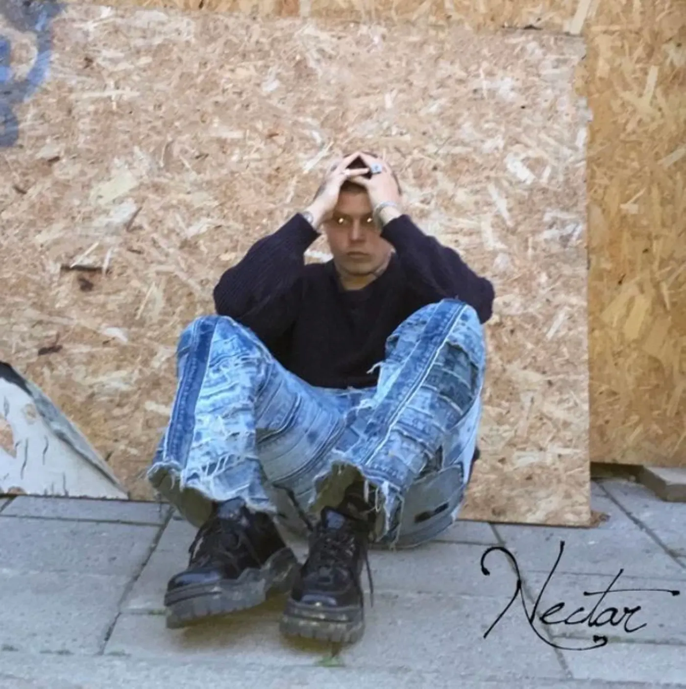 Cover of the 2019 project Nectar by Jonatan Leandoer96, showing him seated against plywood in patent leather Eytys Angel sneakers.